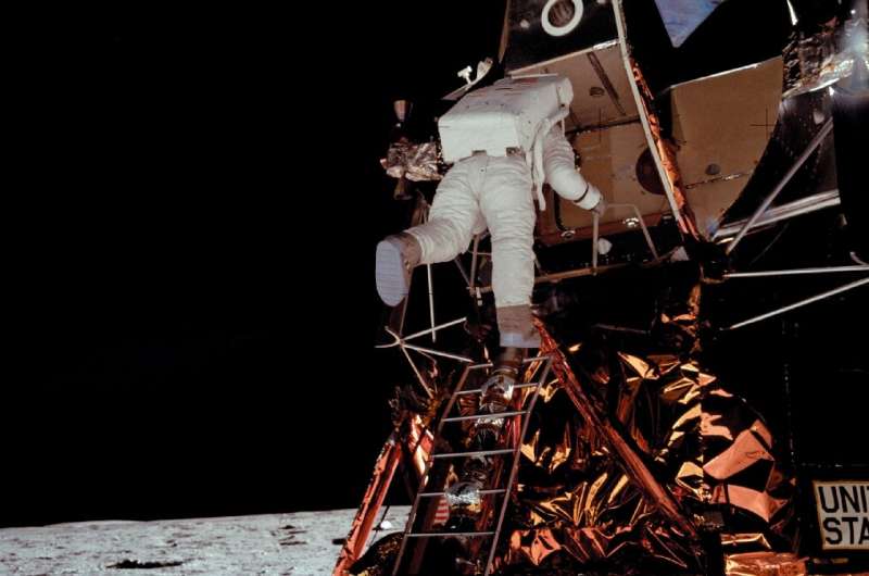 edwin "buzz" aldrin descends from the lunar module to