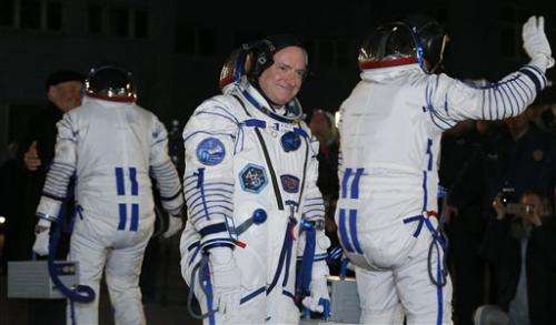 Astronauts board space station for 1-year mission (Update)