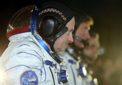 Astronauts board space station for 1-year mission (Update)