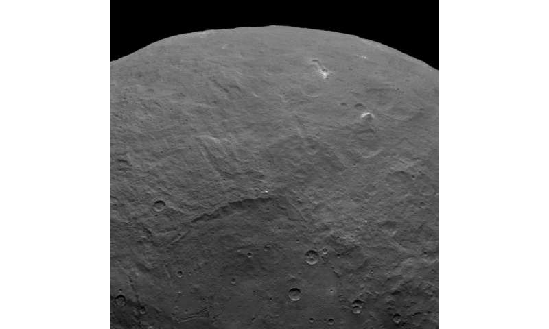 Is that a big crater on Pluto? Pyramidal mountain found on Ceres