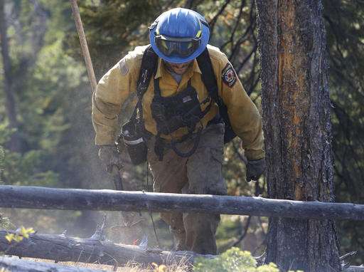 Wildfire blocking Yellowstone entrance smolders on