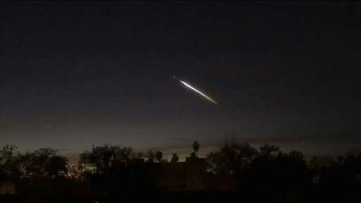 Rocket lights sky as it carries satellites from California