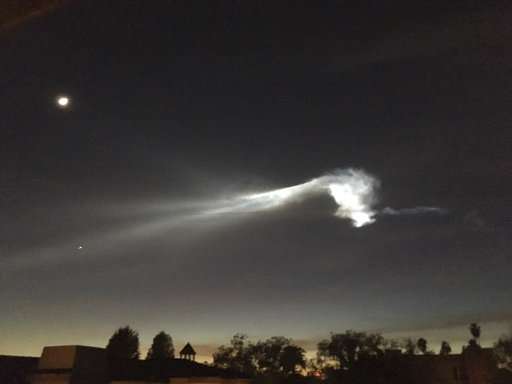 Rocket lights sky as it carries satellites from California