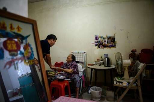 Despite living in the world's third richest territory, Chan Lai (C), who is in her mid 80s, had to rely on charity oin the after