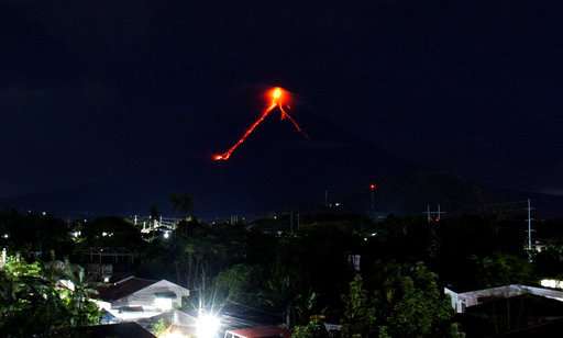 Glowing red lava causes more to flee from Philippine volcano