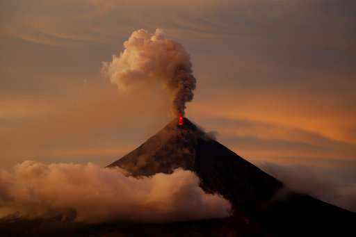 Lava spilling from Philippine volcano, ash coating land