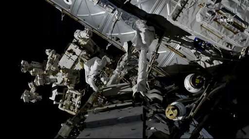 Spacewalking astronauts tackle battery, cable work