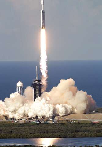 SpaceX launches mega rocket, lands all three boosters