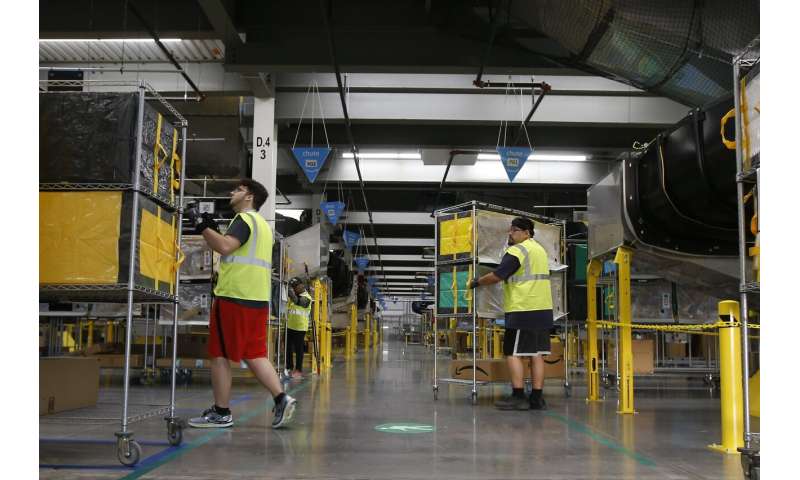 As robots take over warehousing, workers pushed to adapt