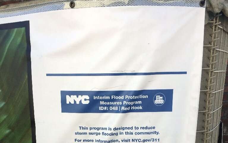 A sign on a sandbag wall from the city of New York informs residents that &quot;Interim Flood Protection Measures Program&quot; 