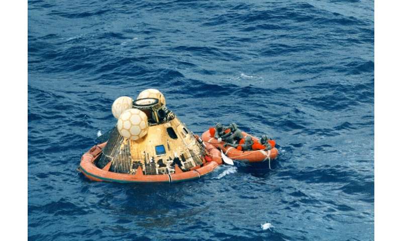 Astronauts Neil Armstrong, Michael Collins and Buzz Aldrin waited in the Hawaii sea on 24 July 1969 to be picked up after the hi