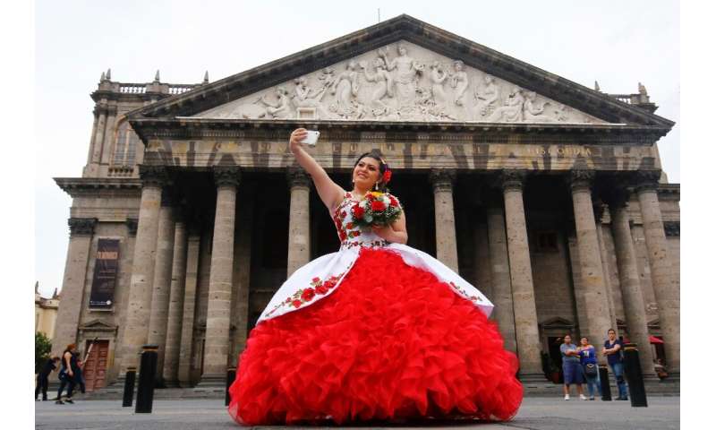 A tourist takes a selfie in front of the neoclassical Teatro Degollado in Guadalajara, Mexico—experts warn the fun can turn sour