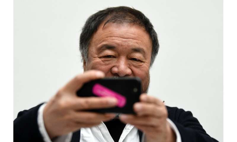 Chinese artist Ai Weiwei has used selfies as a political tool—here, he takes one at a press conference in Dusseldorf, Germany in