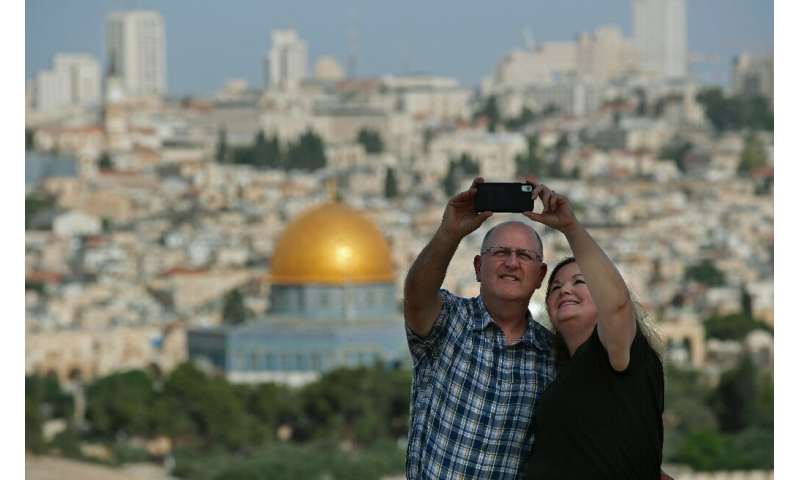 Selfies often feature spectacular backgrounds; here, a couple takes one in front of Jerusalem's Old City from the Mount of Olive