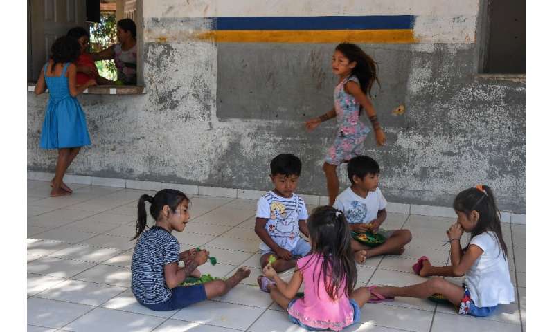 Students have lunch during a break at school in the Praia do Mangue indigenous reserve where Claudeth Gabriel Sau Munduruku work