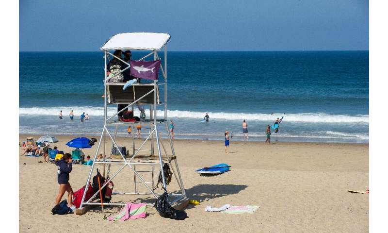The purple flag on this lifeguard station warning of sharks should give swimmers pause when they dive into the waves