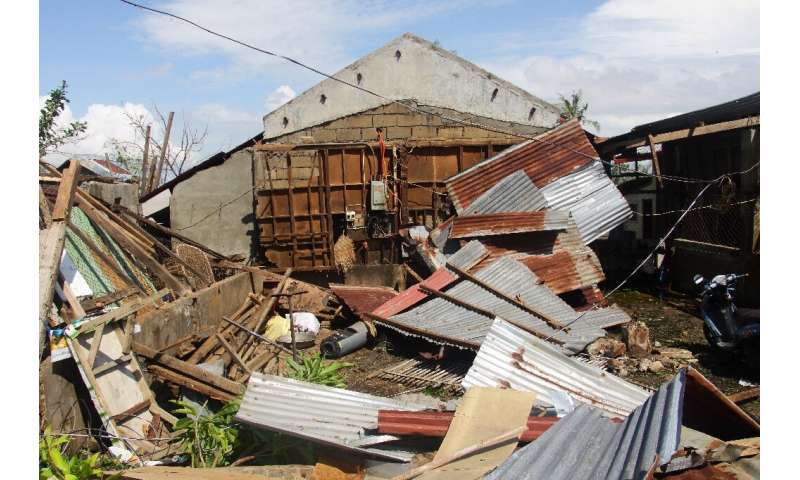 With gusts reaching 200 kilometres (125 miles) an hour, Typhoon Phanfone tore into houses including this one in Balasan town, Il