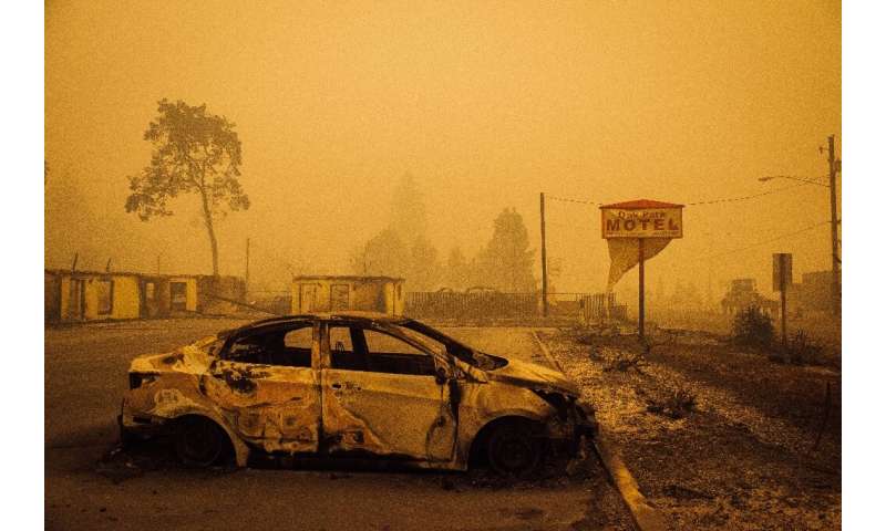 A charred vehicle is seen in the parking lot of the burned Oak Park Motel after the passage of the Santiam Fire in Gates, Oregon