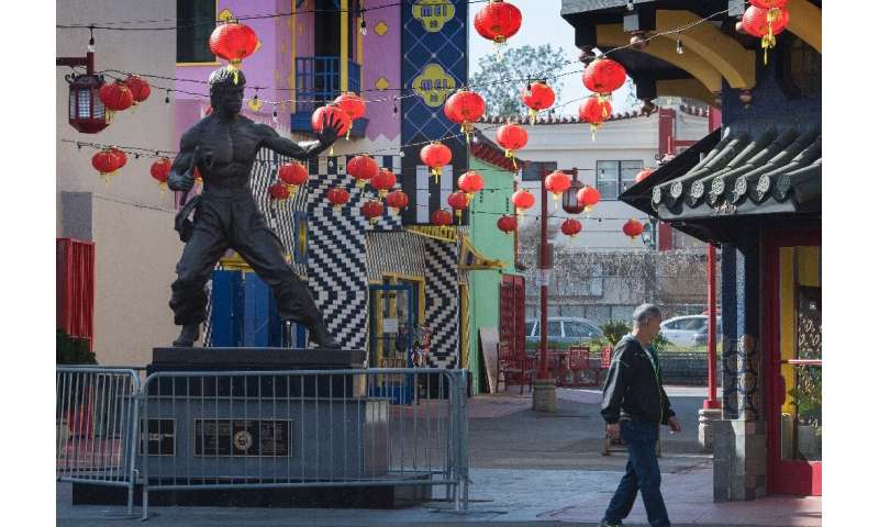A man walks through an almost deserted Los Angeles Chinatown as most stay away due to fears over the novel coronavirus