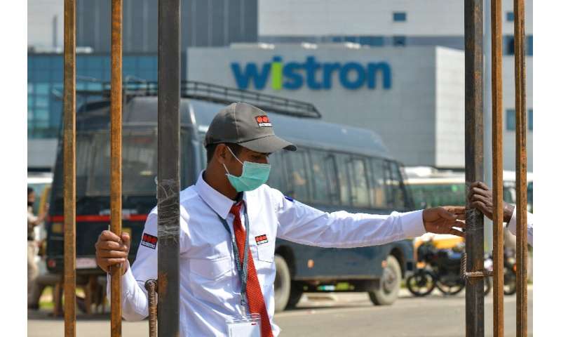 A security guard at the entrance of the Taiwan-run iPhone factory at Narsapura, near Bangalore