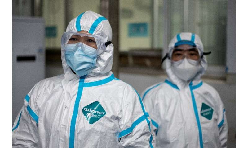 Medical workers wearing hazmat suits as prevention against the COVID-19 coronavirus at work at the Huanggang Zhongxin Hospital i