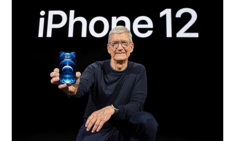 In this photo released by Apple, Apple CEO Tim Cook holds up the all-new iPhone 12 Pro during an Apple event at Apple Park in Cu