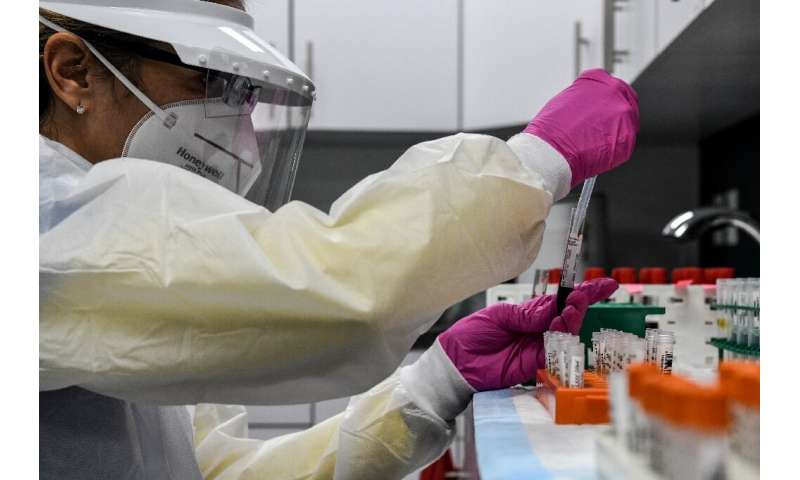 A lab technician sorts blood samples for a Covid-19 vaccination study at the Research Centers of America in Hollywood, Florida i