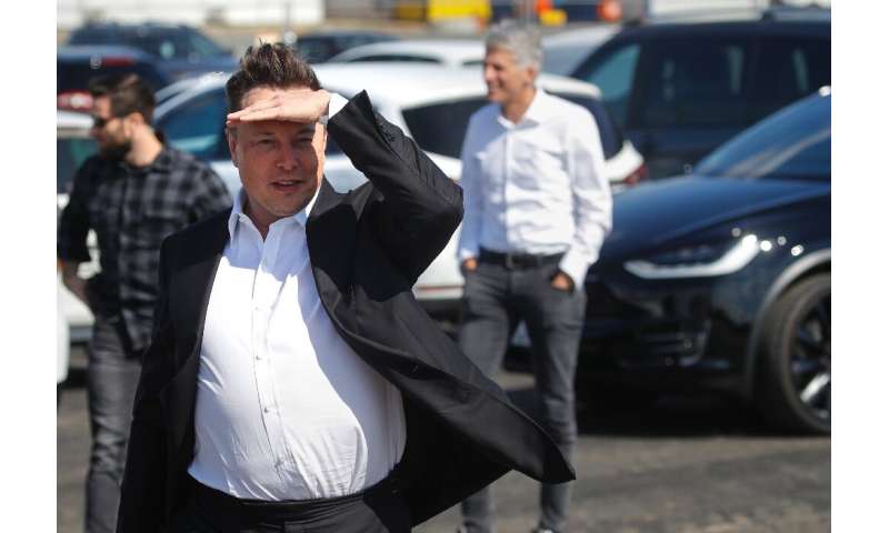 Tesla CEO Elon Musk gestures as he arrives to visit the construction site of the future US electric car giant in Gruenheide near
