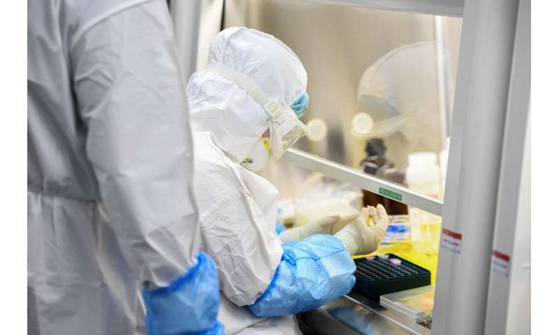 A laboratory technician works on coronavirus samples at &quot;Fire Eye&quot; laboratory in Wuhan