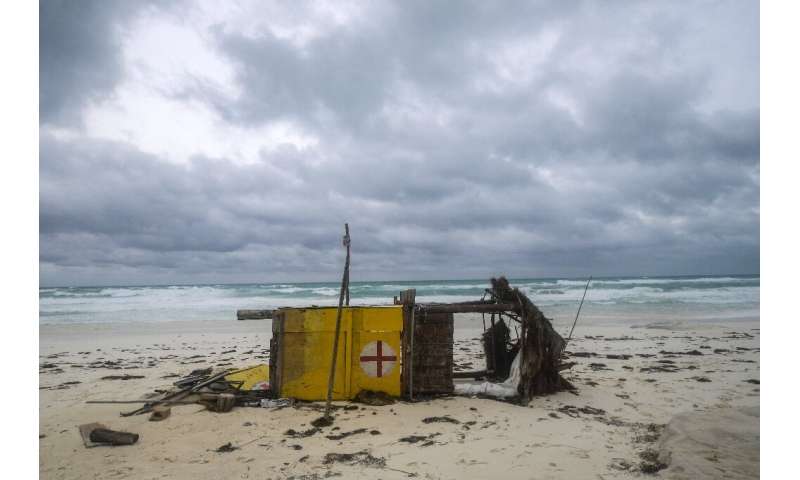 A lifeguard hut blown over by Hurricane Delta lies on its side on a beach in the Mexican resort of Cancun