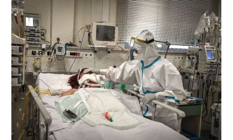 A nurse attends to a patient suffering from Covid-19 in an Athens suburb on November 20, 2020