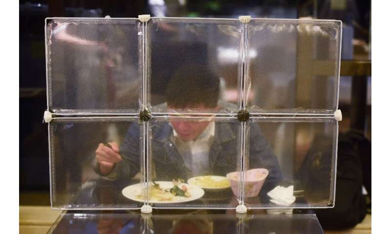 A restaurant in China's eastern Zhejiang province seperates diners with table partitions to prevent coronavirus spread