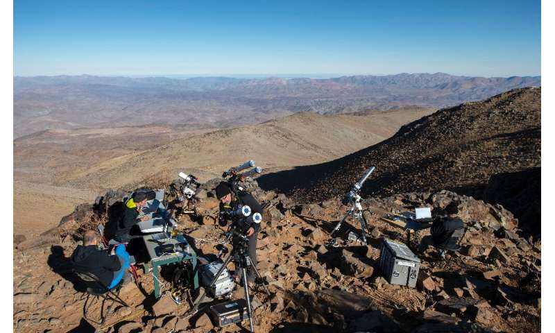 Asronomers preparing telescopes to observe the total eclipse of the sun from the Silla Observatory in the Atacama desert in July