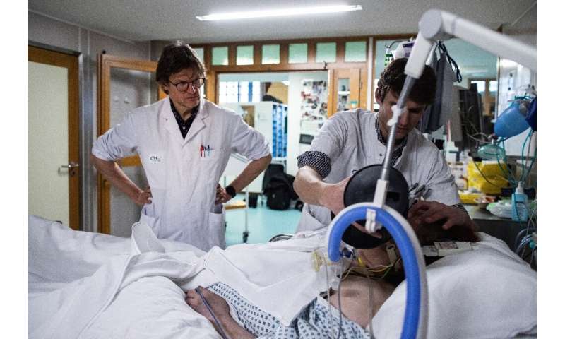 Belgian neurologist Steven Laureys visits a patient at The University Hospital Centre in Liege