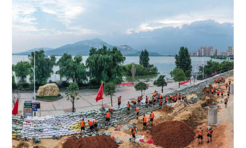 Chinese soldiers erect a sandbag barrier along the shore of Poyang lake after heavy seasonal rains in Jiujiang, in China's centr