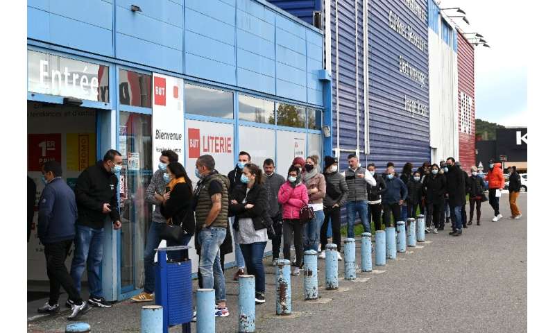 Customers queued outside a furniture store in southeastern France as shops were allowed to lift their shutters for the holiday s