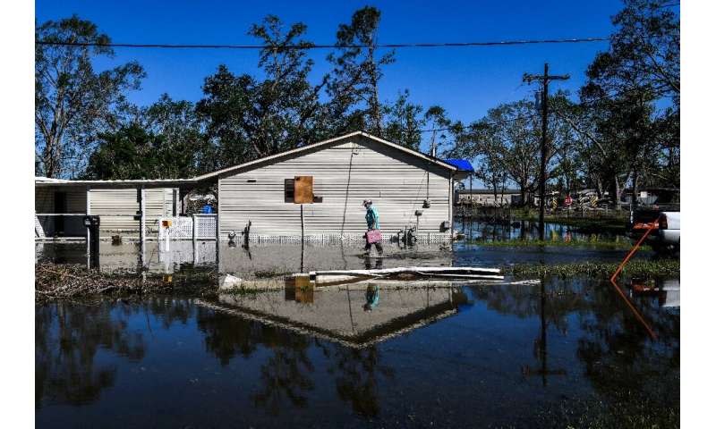 Daniel Schexnayder walks through his flooded yard in the small town of Iowa, Louisiana on October 10, 2020