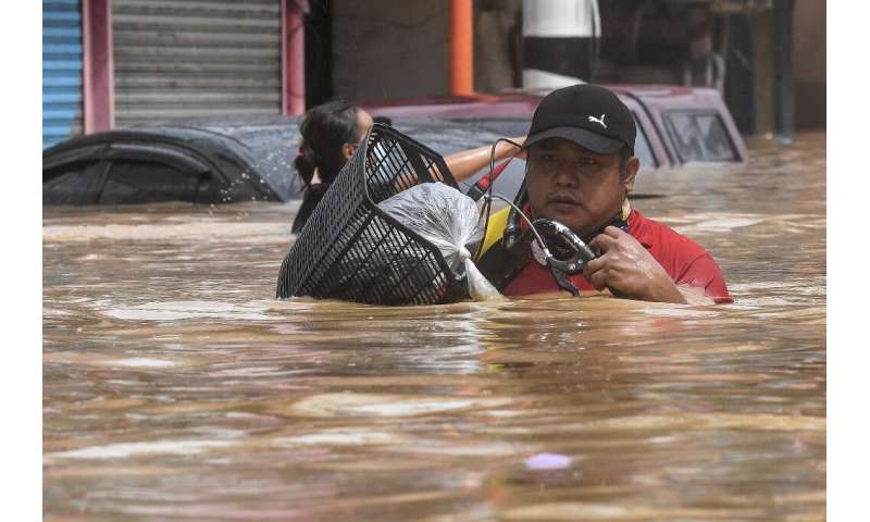 Flood water in some Manila streets was up to shoulder height