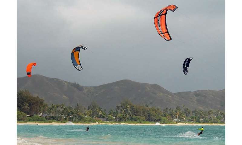 Kite surfers enjoy increasing winds ahead of Hurricane Douglas in the windward town of Kailua on the island of Oahu, Hawaii on J