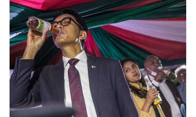 Promoter: President Andry Rajoelina drinks from a bottle of Covid-Organics at the product's launch on April 22