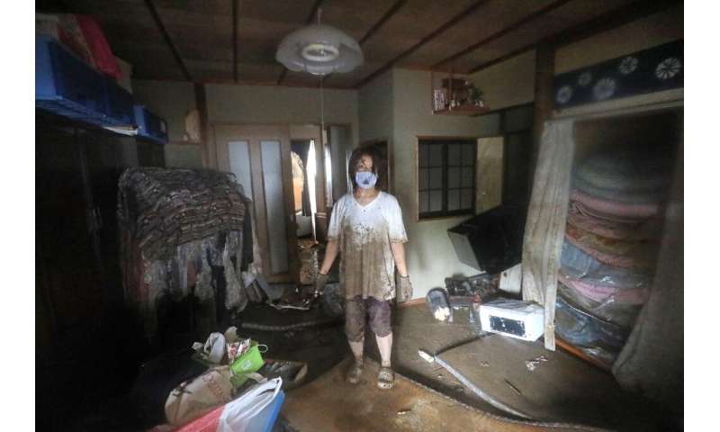 Residents in Kumamoto clean up as floods and mudslides hit the region in southwestern Japan