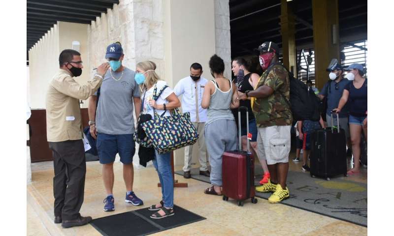 Tourists are evacuated from their hotel in Puerto Morelos in Mexico in preparation for the arrival of Hurricane Delta