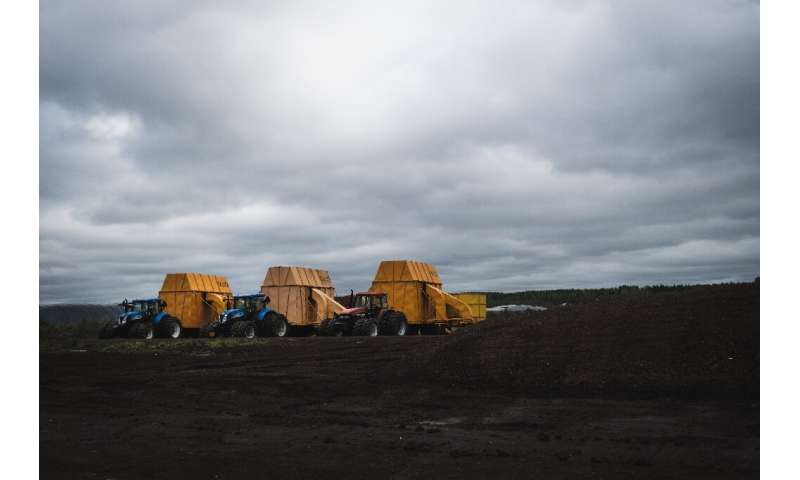Tractors and peat faming machineries are lined up in Taisto Raussi's peat fields in Sippola, Finland