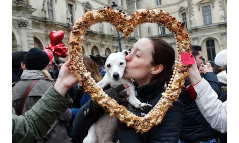 True love: a woman and her Valentine's Day date pose behind a heart-shaped pastry during a February 14 Paris flash mob