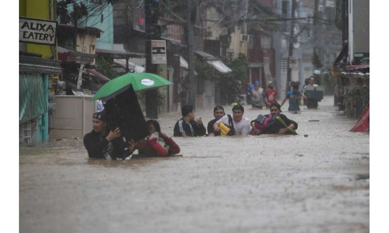 Typhoon Vamco brought heavy flooding to suburban Manila on Thursday, with authorities warning of life-threatening storm surges o