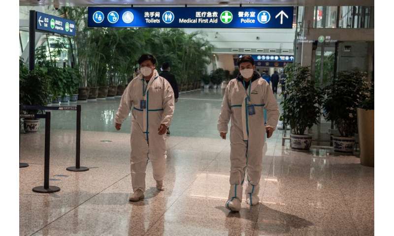Health workers were waiting to meet the WHO team as they arrived in Wuhan on Thursday ahead of their probe into the origins of t