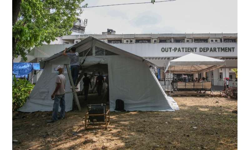 The government is distributing modular tents to struggling hospitals and re-deploying health workers from regions where virus tr