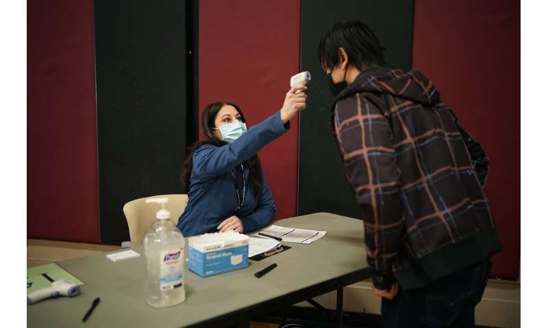 Volunteers are key at vaccine sites. It pays off with a shot