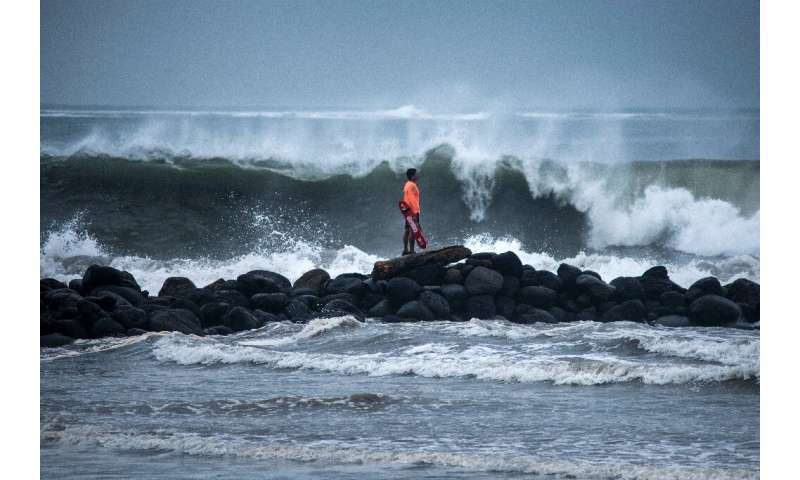 Lifeguards monitor the waves crashing against the coast of Boca del Rio in Veracruz, eastern Mexico, as the hurricane race approaches.