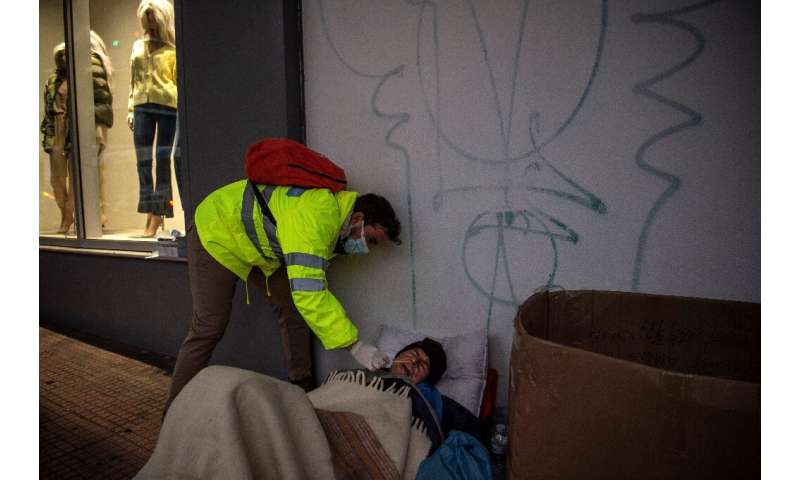 A nurse in Athens takes a swab from a homeless man for an antigenic test as Greece faces a new wave of Covid-19 infections